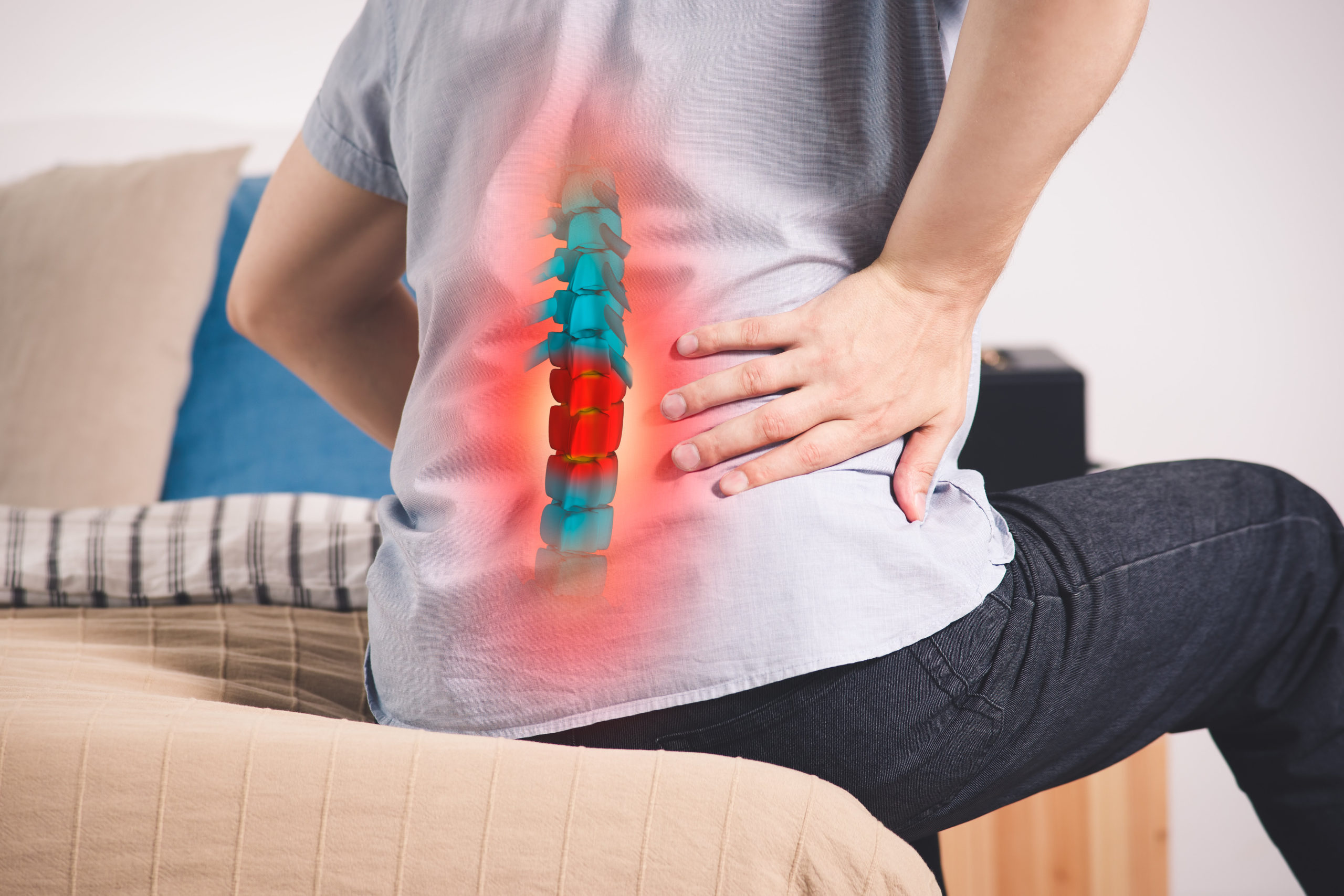man holding lower back in pain