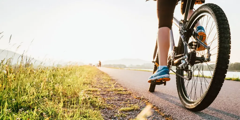 woman riding bike down road