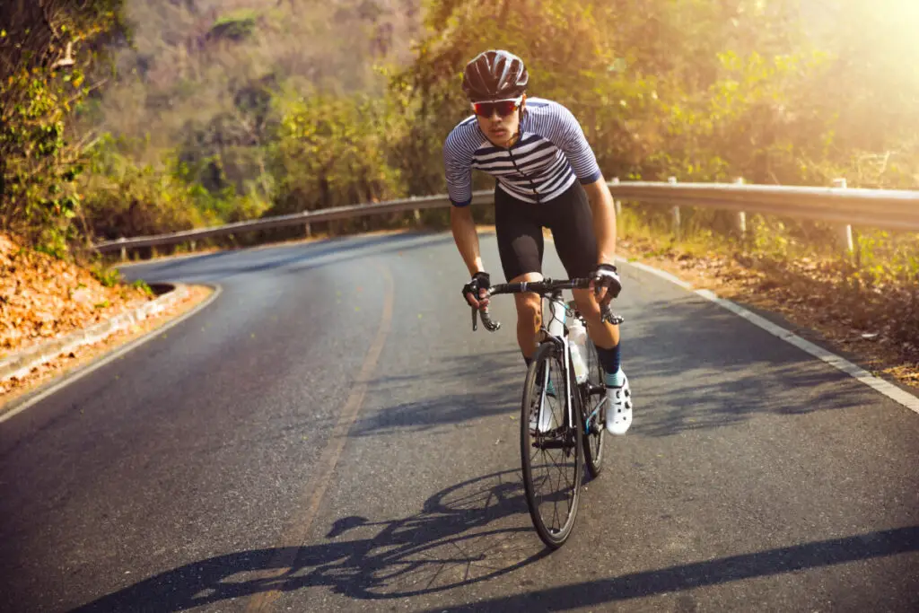 Asian men are cycling road bike in the morning.He is on a forest