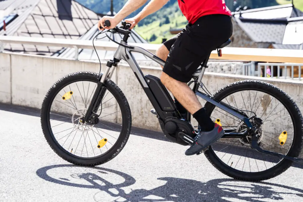 man riding e-bike on street